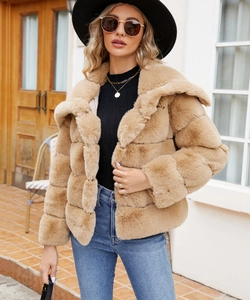 Close-up of camel faux fur jacket with wide lapels and layered horizontal stitching