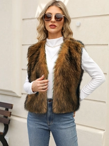 Detail of fluffy brown faux fur vest texture paired with a white turtleneck and denim