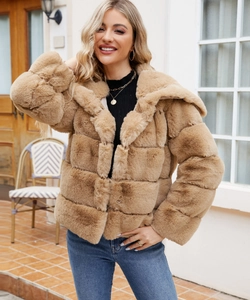 Detail of light brown faux fur jacket showing plush texture and quilted segment design