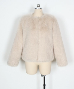 Detail view of high-quality beige faux fur texture on a cropped collarless jacket
