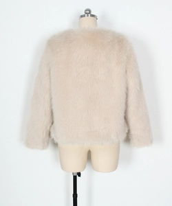 Close-up back view of a plush beige faux fur jacket with soft fluffy texture and round neck