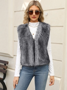 Detail of grey faux fur vest texture with long fluffy hair and stylish V-neck cut