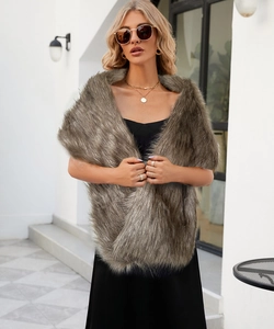 Detailed texture of thick faux fur shawl in taupe worn with an elegant black dress