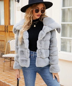 Detail of light grey faux fur jacket with wide lapel and soft striped texture on model