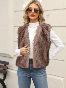 Outdoor street style view of a soft brown faux fur vest with long plush texture and V-neck