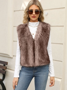 Detail shot of plush dark brown faux fur vest with V-neckline on a female model