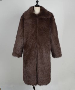 Close-up of thick dark brown faux fox fur texture and material on a long winter coat
