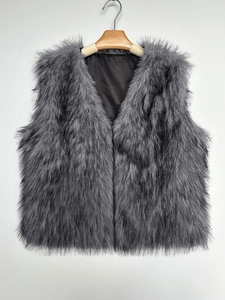 Detail of grey faux fur vest showing layered fluffy texture and sleek black inner lining