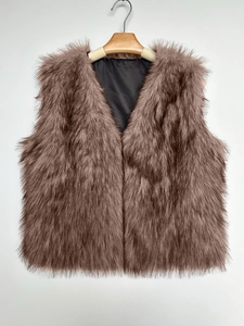 Detail of tan faux fur vest with soft long texture and smooth black fabric lining