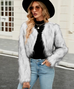 Detail shot of white faux fur short jacket showing plush texture and grey-black tips