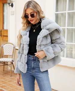 Detail of light gray faux fur jacket with hood showing soft horizontal stripe texture