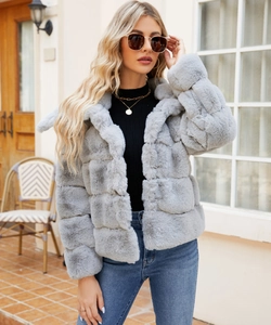Detail of grey faux fur coat with square patchwork texture and wide lapel collar