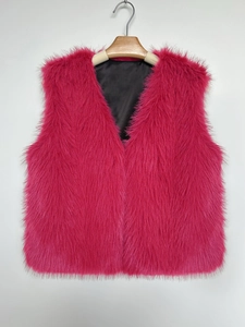 Detailed close-up of rose pink faux fur vest featuring soft texture and black satin lining
