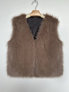 Detail of brown faux fur vest featuring long glossy hair texture and elegant V-neckline
