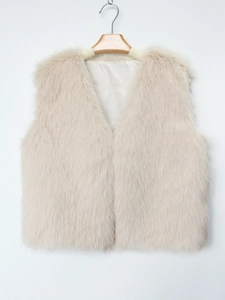 Detail of soft faux fur texture and smooth inner lining on a pale pink V-neck vest