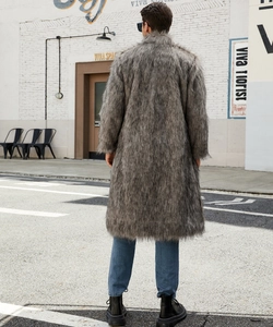 Back view of a long dark grey faux fox fur coat for men in an outdoor street setting