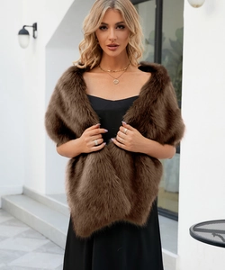 Close-up of deep brown faux fur shawl with plush texture worn over a black dress