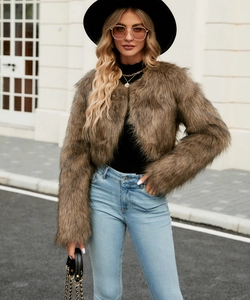 Detail of fluffy brown faux fur jacket showcasing long shaggy texture and open front design