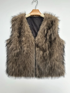 Detail of fluffy brown faux fur vest texture and smooth black inner lining fabric