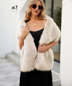 Chic beige faux fur shawl on a black dress, showcasing soft fluffy texture for elegant events