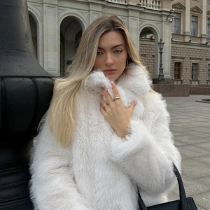 Detail of premium white faux fur texture on a long winter coat with a high neck design