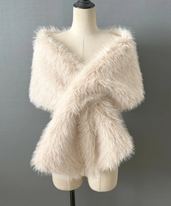 Detail of soft beige faux fur bridal shawl with thick fluffy texture and crossover fit