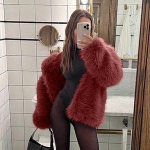 Macro shot of fluffy burgundy faux fur coat texture and long plush material design