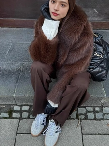 Women's brown faux fur coat for autumn winter styled with trousers and black accessories