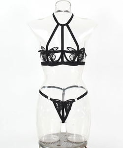 Detail of black strapless lace lingerie set featuring butterfly embroidery and straps
