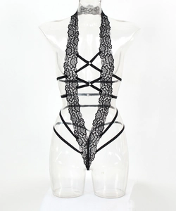 Detail of black lace bodysuit featuring deep V halter neck and criss-cross straps