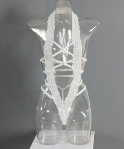 Detail of white lace bodysuit featuring deep V-neck and crisscross strap design
