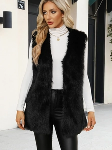 Detail of the soft black faux fur vest texture on model wearing a white top