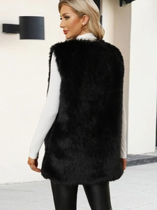 Detailed texture of black faux fur vest with long fibers and fluffy urban fashion style