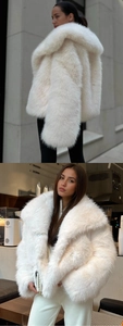 Détail d'un manteau en fausse fourrure blanche avec large revers et texture douce