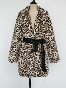 Detail of faux fur leopard coat featuring a large lapel and black bow leather belt