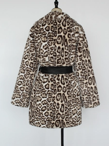 Detail of faux fur leopard coat featuring a large lapel and black leather waist belt