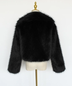 Close-up of black faux fur jacket showing dense texture and glossy finish on mannequin