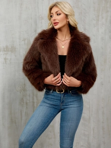 Detail of plush dark brown faux fur jacket featuring a wide lapel and thick texture