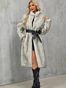 Detailed view of long faux fur coat with chic black leather bow belt and stand collar
