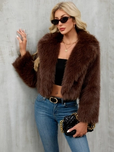 Detailed view of dark brown faux fur jacket with lapel collar and plush texture