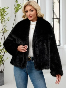 Detail of plush faux fur texture on a black cropped jacket with large lapels
