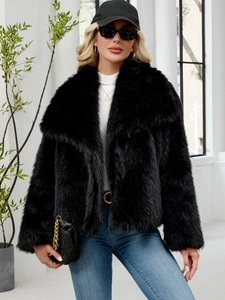 Detail of black faux fur coat showing thick texture and stylish wide lapel collar