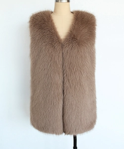 Detail of faux fur vest in dark brown featuring fluffy texture and V-neckline design