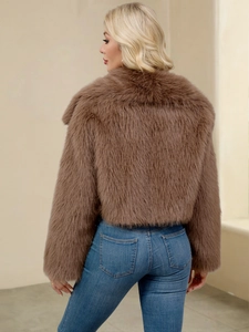 Back view of a cropped brown faux fur jacket with thick texture and slim fit design