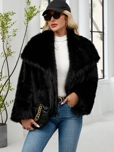 Detailed view of the luxury black faux fur jacket featuring a wide collar and plush texture