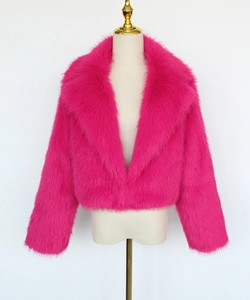 Close-up of fluffy faux fur texture and wide lapel collar on a hot pink cropped jacket