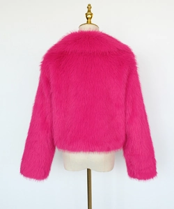 Detail of luxurious faux fox fur texture on women's cropped jacket in vibrant hot pink