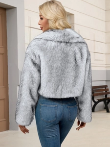 Back view of a cropped faux fur jacket in greyish-white with fluffy plush texture