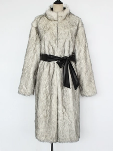 Detailed view of the long faux fur coat featuring a black leather belt with bow tie