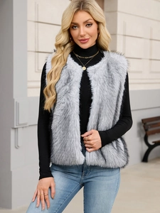 Close-up of faux fur vest featuring long light gray hair with black tips in natural sunlight